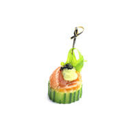 2528. Smoked salmon rolled with avocado cream on a cucumber
